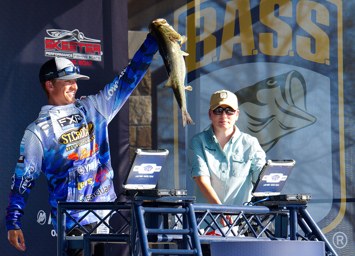 Trey McKinney holds up his catch at weigh-in Saturday. He went on to win the four-day Bassmasters tournament.